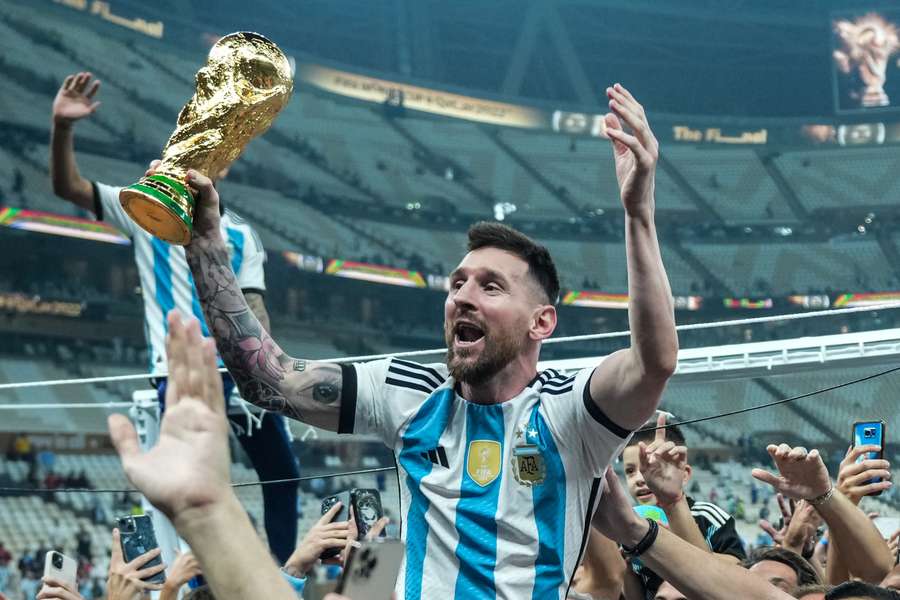 Lionel Messi of Argentina celebrates with the World Cup trophy in 2022