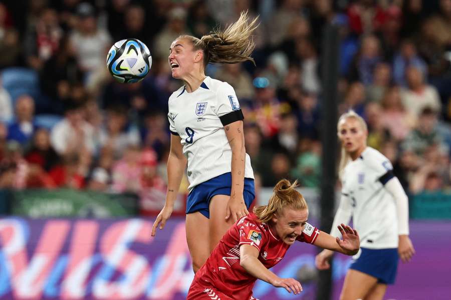 Denmark's midfielder #06 Karen Holmgaard (R) and England's midfielder #08 Georgia Stanway fight for the ball