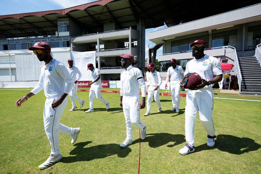 West Indies players walk on the pitch on the first day of the second test in Bulawayo