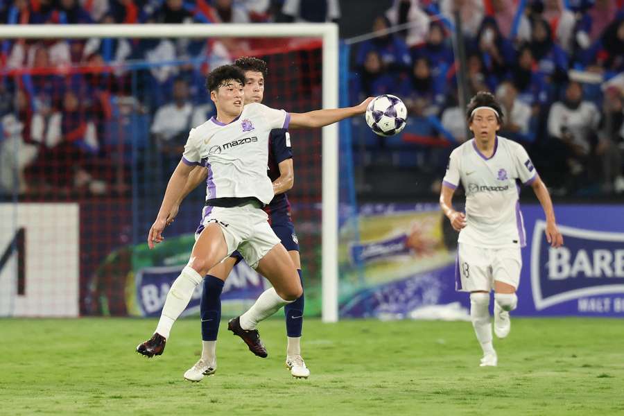 Akito Suzuki of Sanfrecce Hiroshima battles for possession Akito Suzuki of Sanfrecce Hiroshima battles for possession