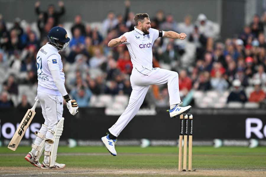 England's Chris Woakes celebrates taking the wicket of Sri Lanka's Angelo Mathews