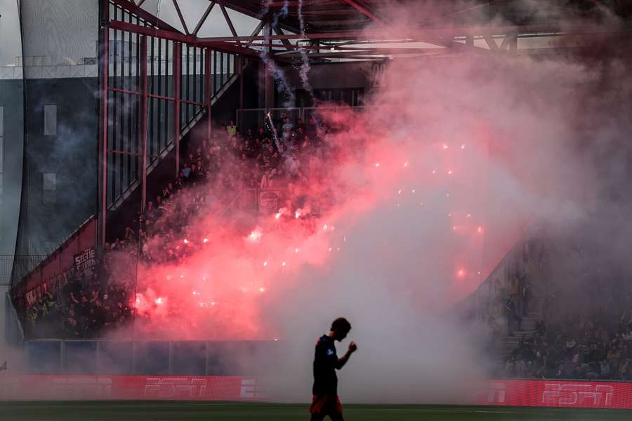 Feyenoord fans set off fireworks in the away end Feyenoord fans set off fireworks in the away end