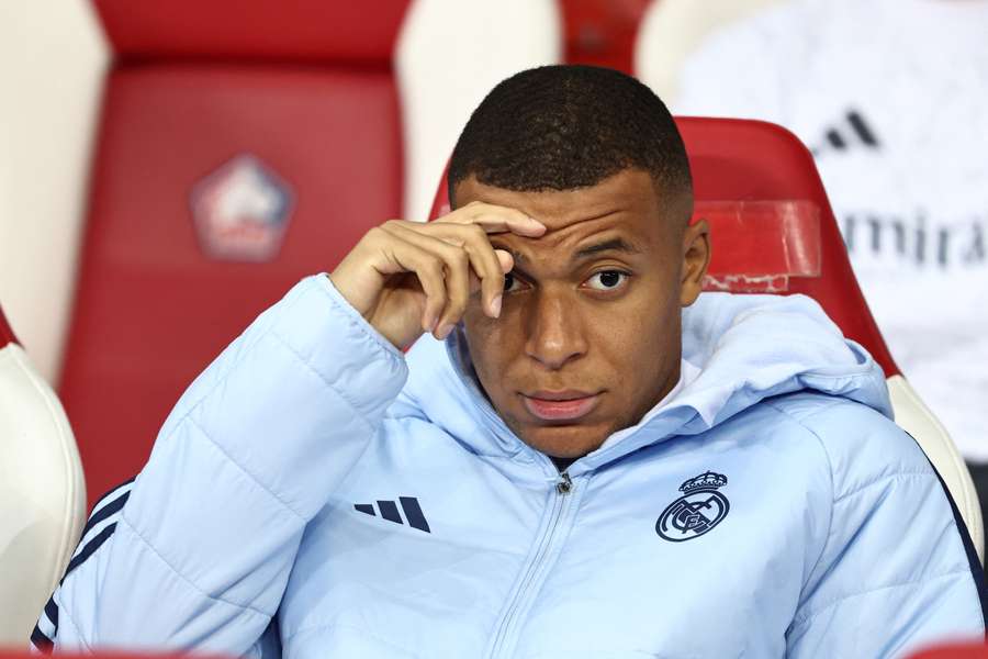 Real Madrid's French forward #09 Kylian Mbappe looks on from the bench