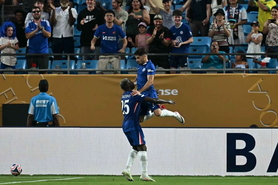 Pedro Neto celebrates with Moises Caicedo after scoring Chelsea's third goal