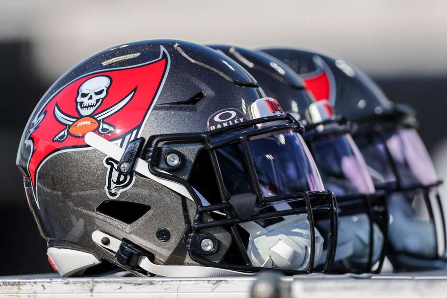 Tampa Bay Buccaneers helmets stacked on the sidelines (2024)