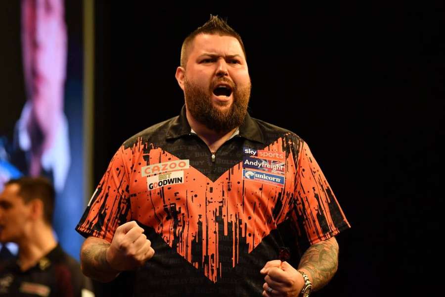Michael Smith celebrates after beating Gerwyn Price in the final