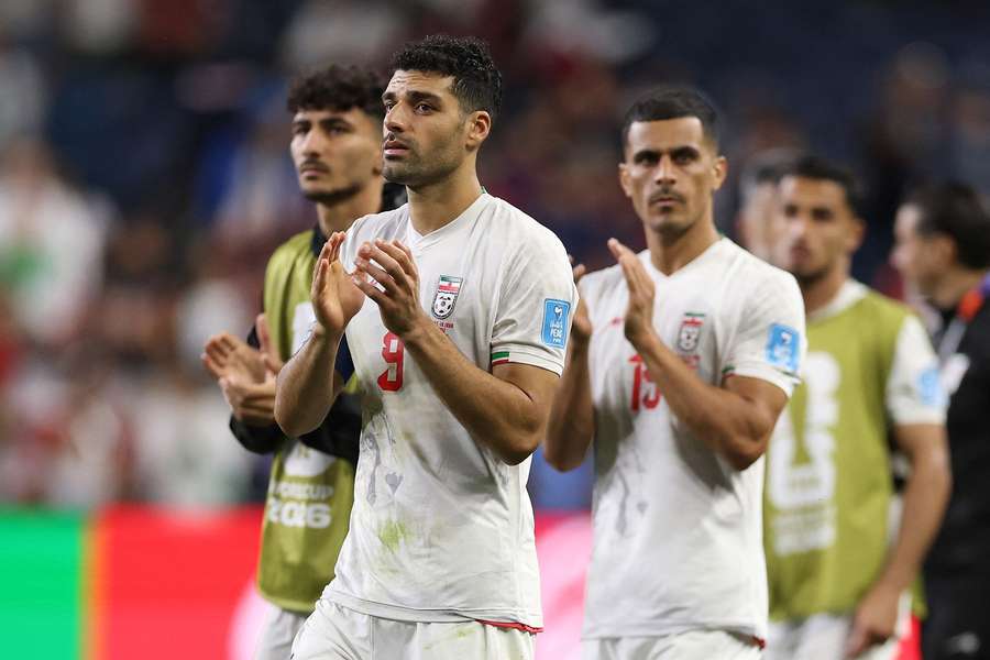 Mehdi Taremi leads his Iran teammates in applauding the fans