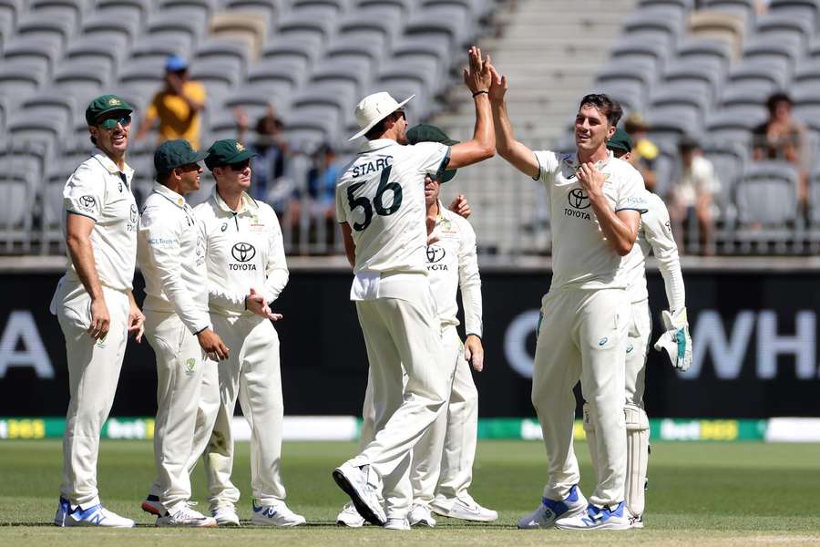 Cummins and Australia celebrate the wicket of Babar