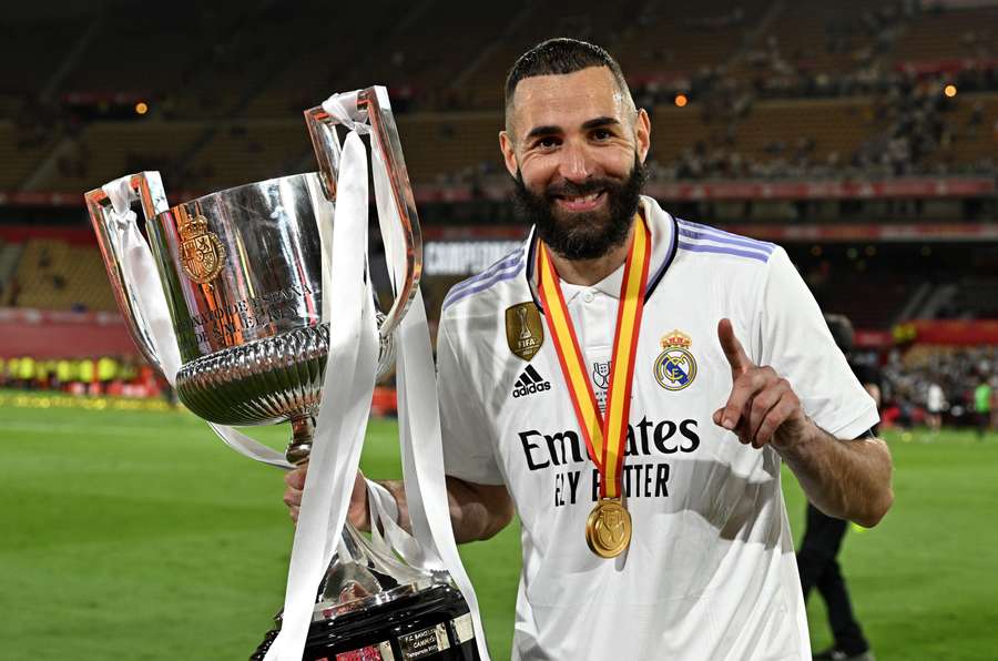 Real Madrid forward Karim Benzema holds the Copa del Rey trophy