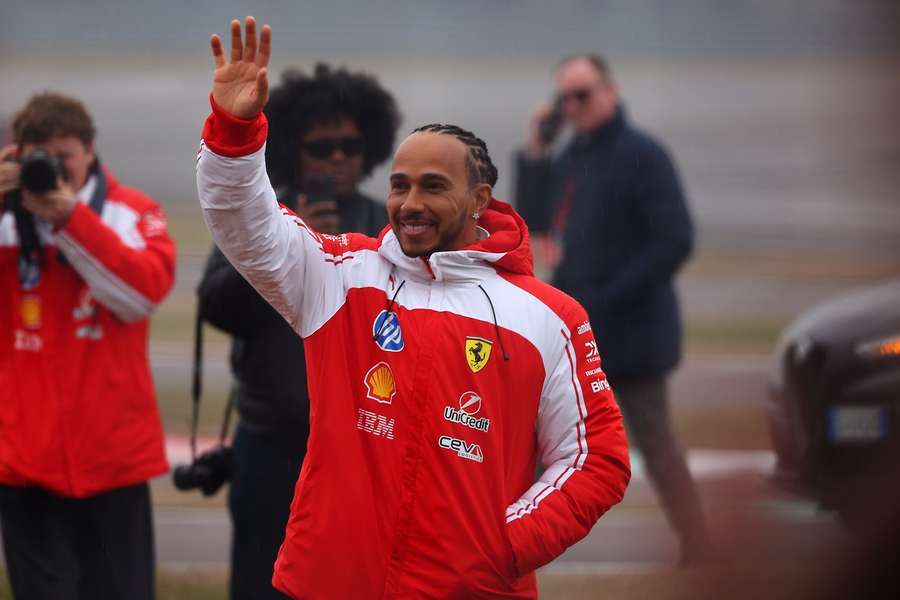 Hamilton waves to fans at Ferrari's car unveiling
