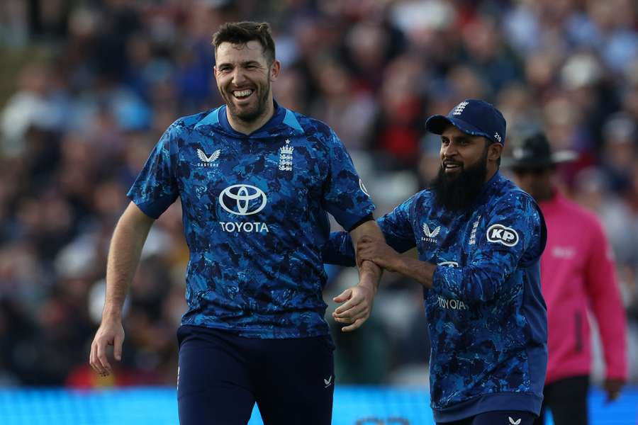 England duo Jamie Overton and Adil Rashid celebrate after taking the wicket of West Indies' Matthew Forde last month