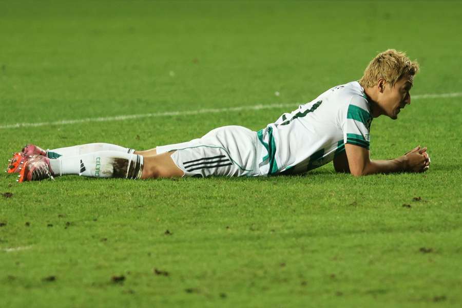 Daizen Maeda lies on the pitch after missing a glorious chance to give Celtic the lead in normal time