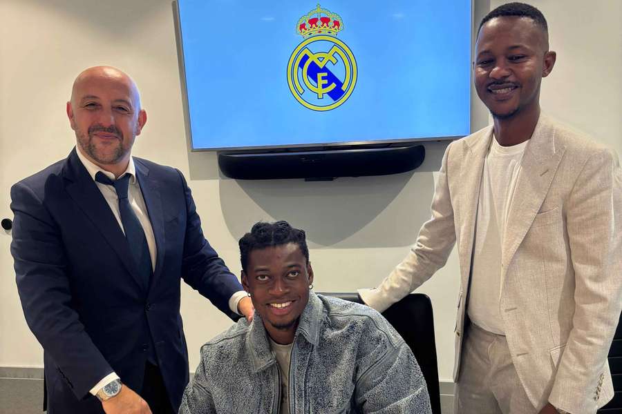 Naasei, firmando su contrato con el Castilla en presencia de Óscar Ribot, su agente, a la izquierda