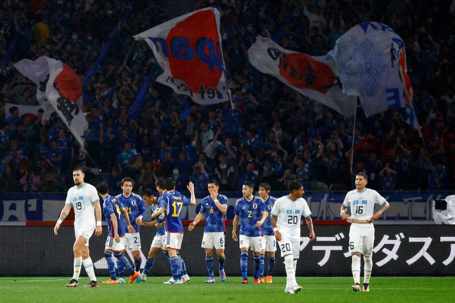 Japan's Takuma Nishimura celebrates with teammates after scoring their first goal