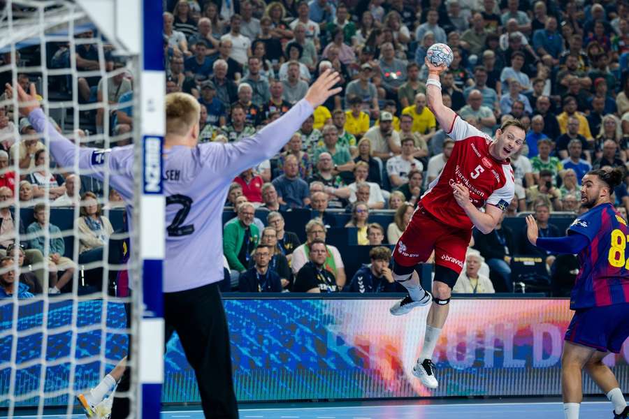 Aalborg's Sander Sagosen comes face-to-face with Barcelona keeper Emil Nielsen. Aalborg's Sander Sagosen comes face-to-face with Barcelona keeper Emil Nielsen.