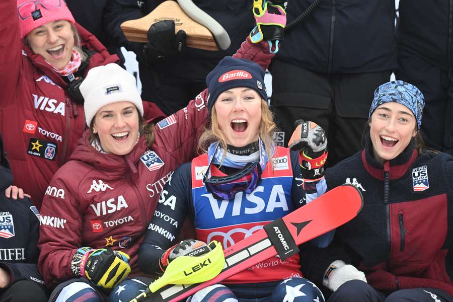 Mikaela Shiffrin celebrates with her team after winning the World Cup title in Špindlerův Mlýn