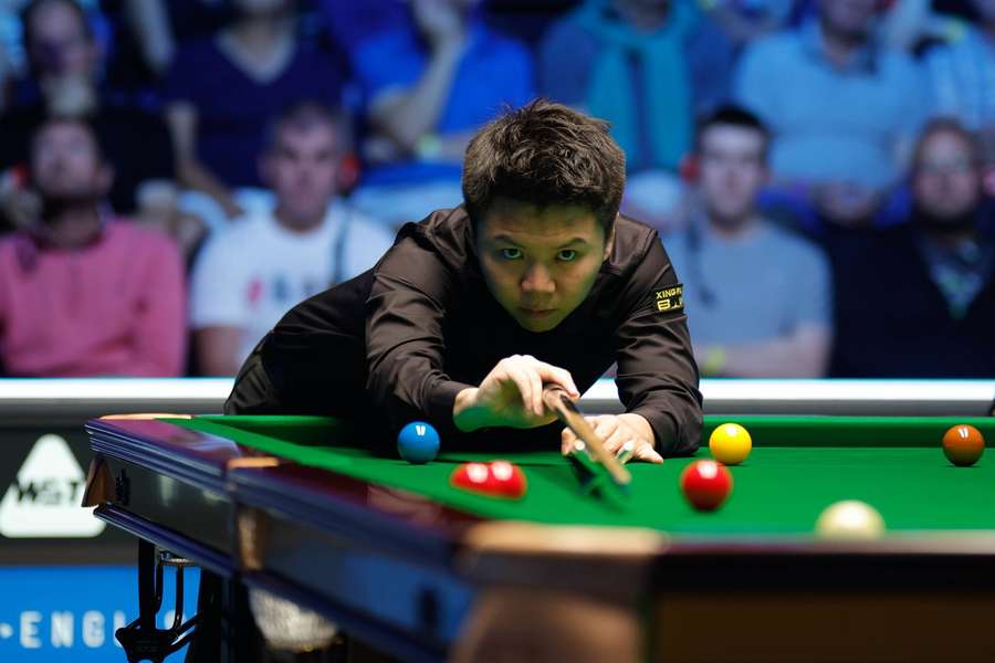 Zhou Yuelong of China plays a shot