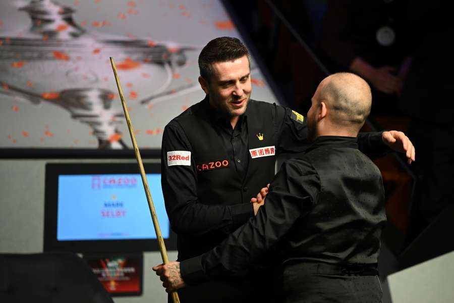 Belgium's Luca Brecel (R) is congratulated by England's Mark Selby after winning the World Championship Snooker final