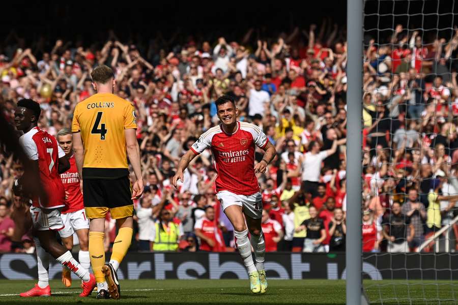 Arsenal's Swiss midfielder Granit Xhaka (C) celebrates after scoring the opening goal during the English Premier League football match between Arsenal and Wolverhampton Wanderers