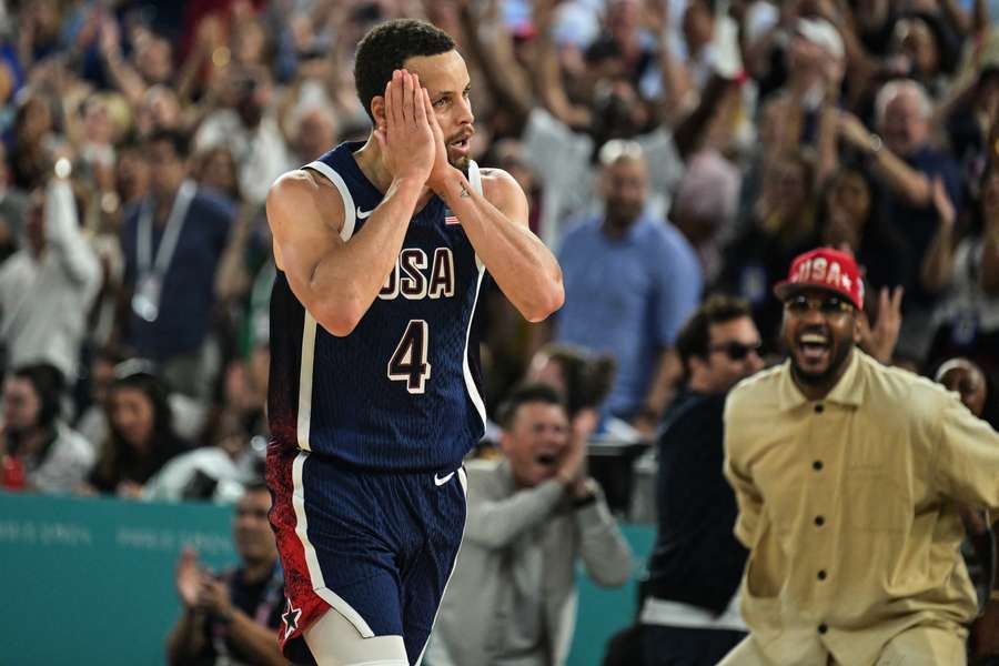 Stephen Curry celebrates scoring a three-point