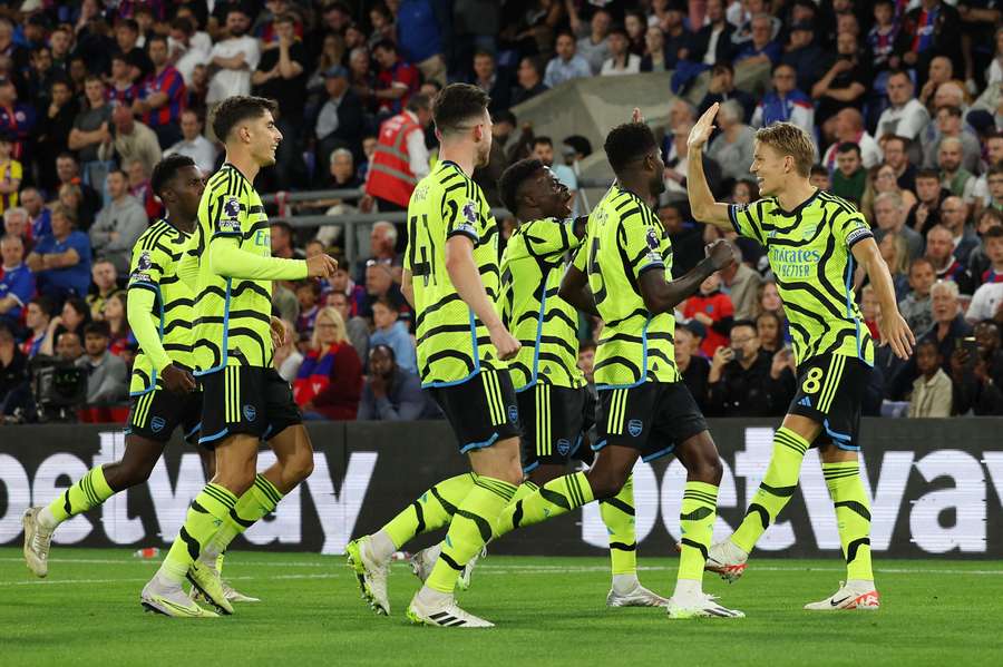 Arsenal's Norwegian midfielder #08 Martin Odegaard (R) celebrates scoring his team's first goal