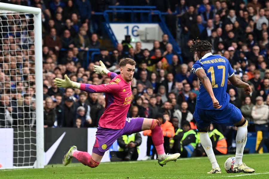 Chelsea midfielder Carney Chukwuemeka (R) shoots to score their third goal past Leicester City goalkeeper Jakub Stolarczyk