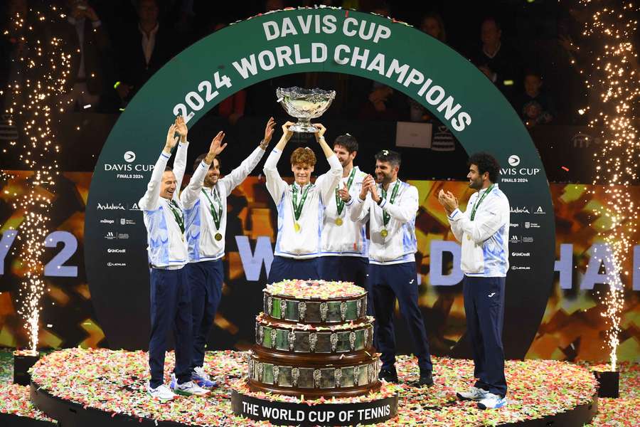 Sinner holds the Davis Cup trophy aloft