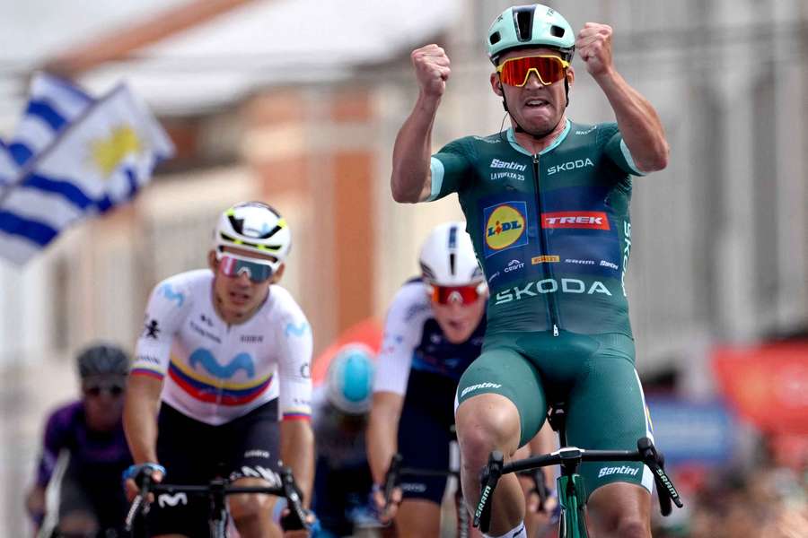 Mads Pedersen celebrates after winning the 15th stage of the Vuelta a Espana