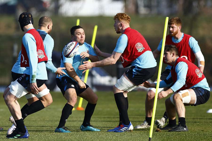 Jamie George and Ollie Chessum with teammates during training