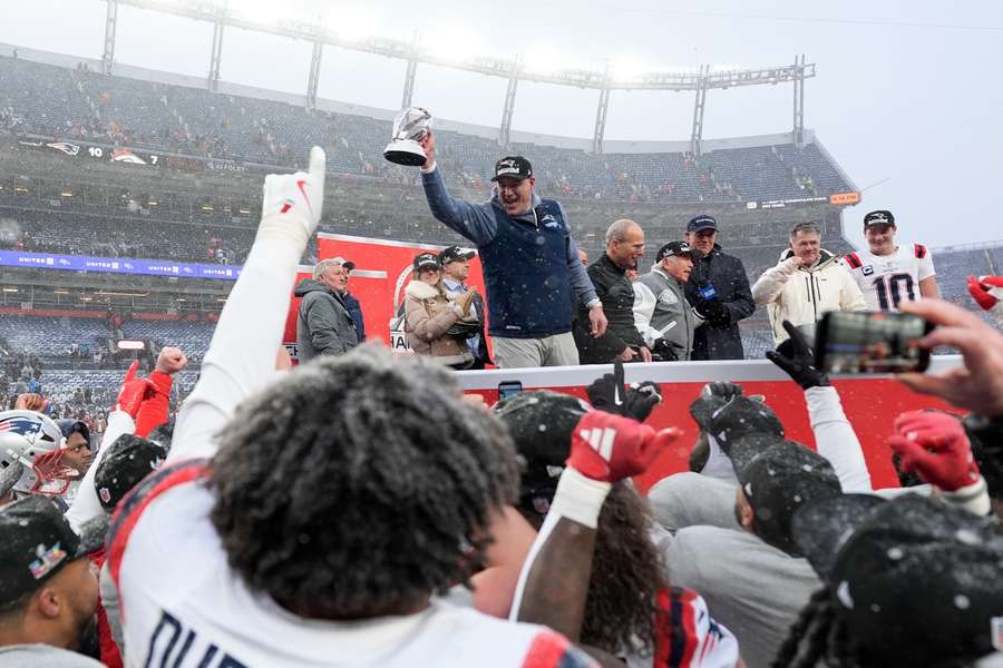 New England Patriots head coach Mike Vrabel holds the trophy after the AFC Championship NFL football game against the Denver Broncos