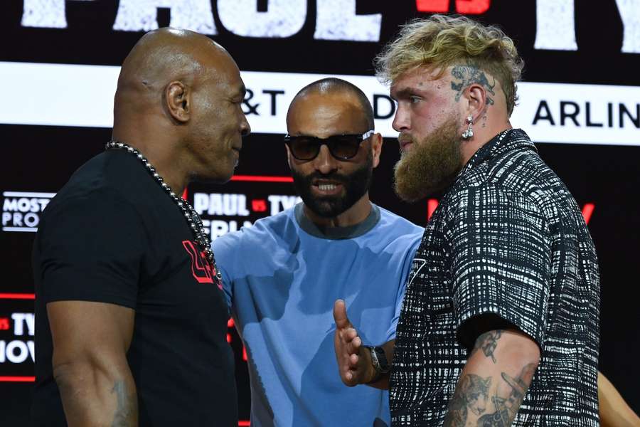 Mike Tyson, Ryan Clark and Jake Paul pose onstage during a press conference