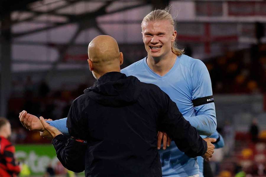 Haaland celebrates after the game with Guardiola