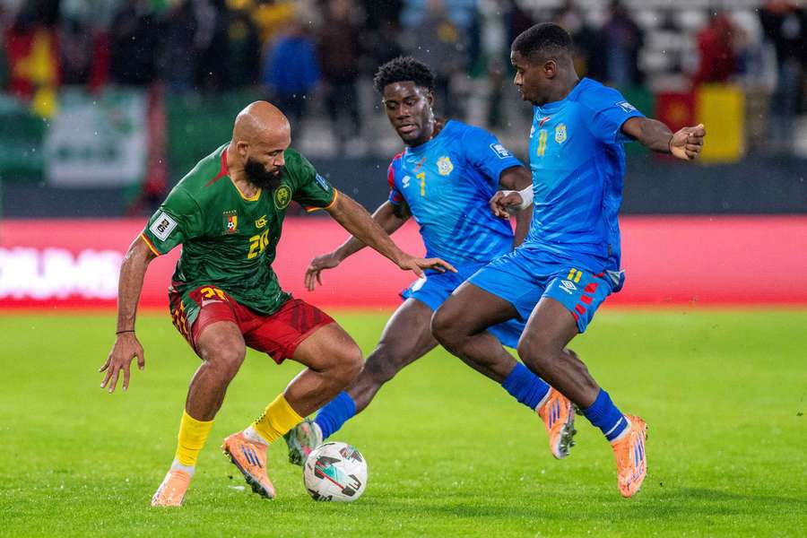 Cameroon's Bryan Mbeumo in action with Democratic Republic of Congo's Noah Sadiki and Nathanael Mbuku 