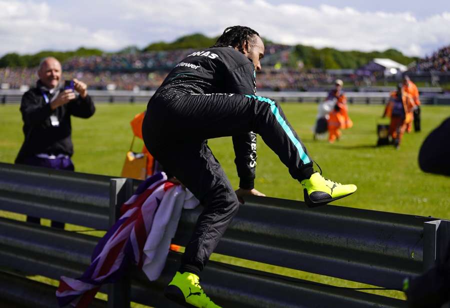 Hamilton jumps the barrier to celebrate