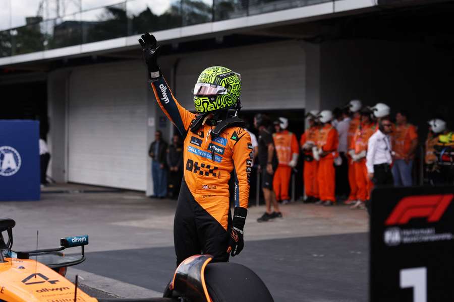 Lando Norris celebrates after securing pole position