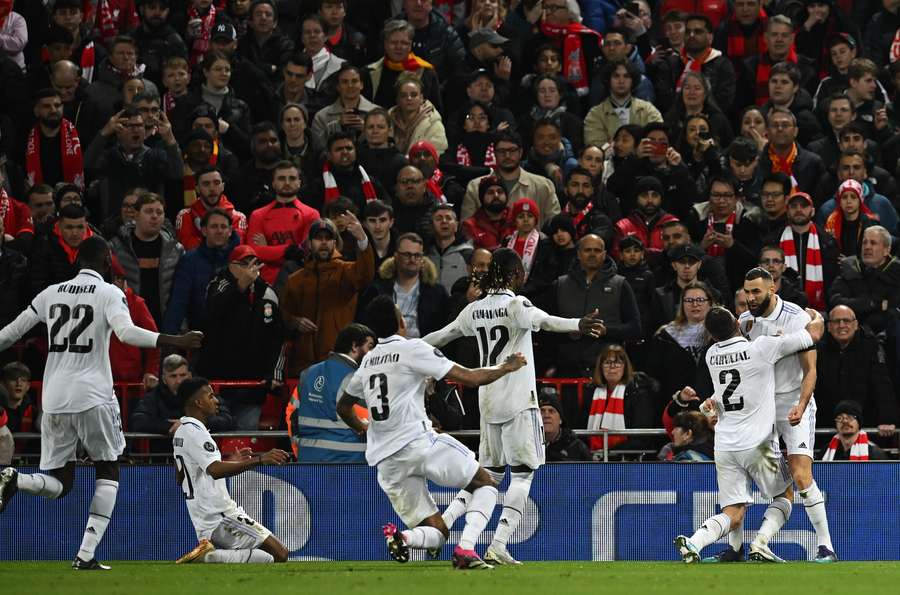 Benzema is swarmed by teammates after scoring the fourth goal