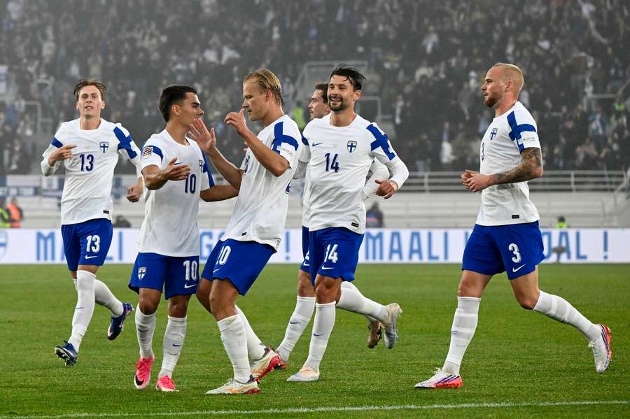 Finland players celebrate Leo Walta's (10) equaliser