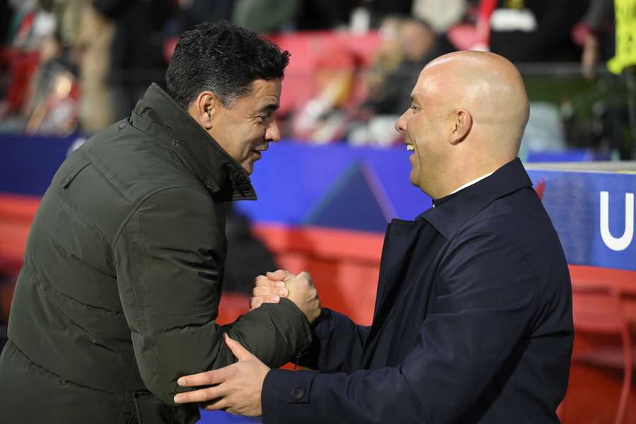 Girona manager Míchel (L) shakes hands with Liverpool's Arne Slot ahead of their Champions League meeting in December 2024