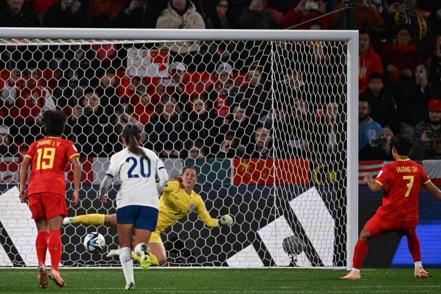 China's forward #07 Wang Shuang (R) converts a penalty to score her team's first goal