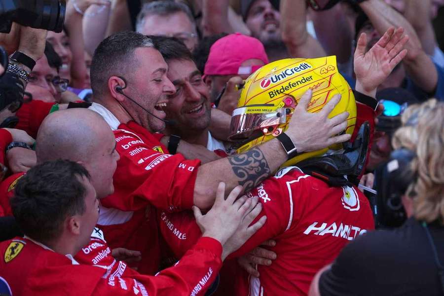 Lewis Hamilton (R) celebrates his win