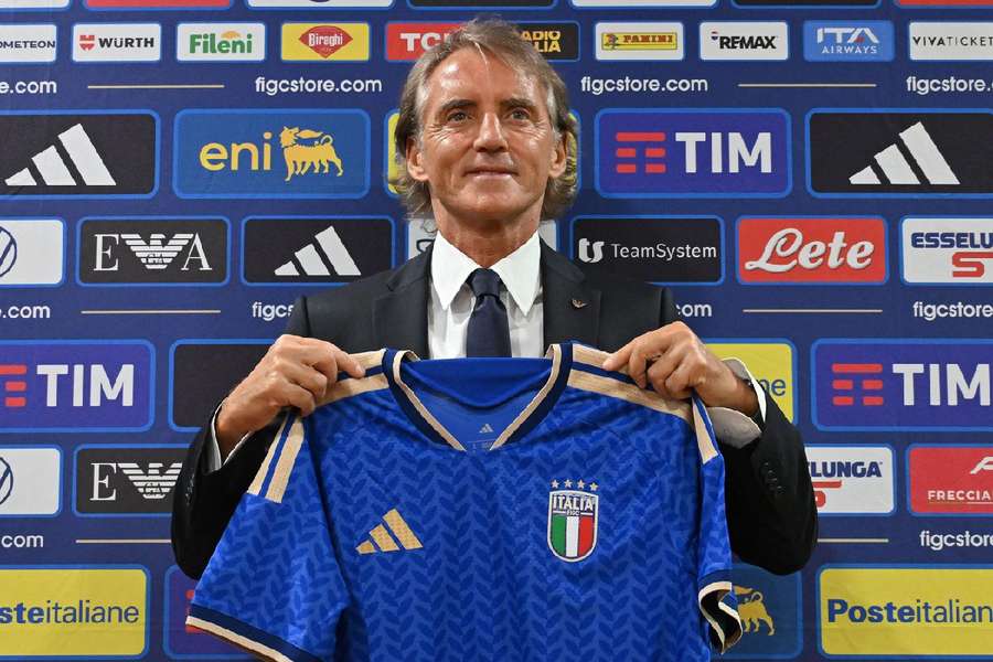 Roberto Mancini holding up the Italy shirt during his presentation Roberto Mancini holding up the Italy shirt during his presentation
