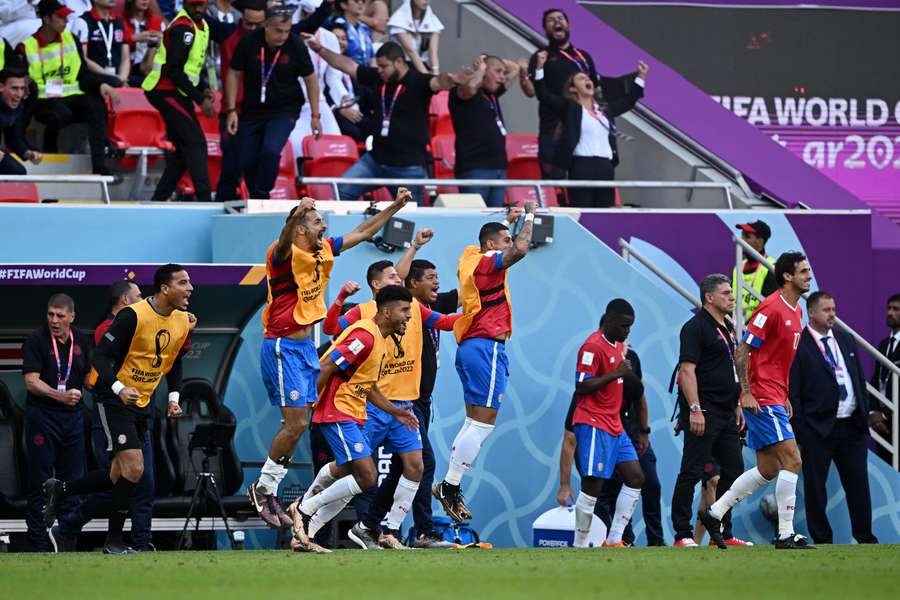 Costa Rica's bench erupts after their winning goal against Japan