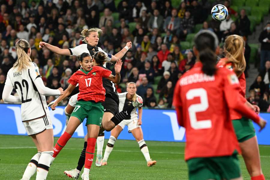 Germany forward Alexandra Popp (3L) heads the ball and scores her team's first goal