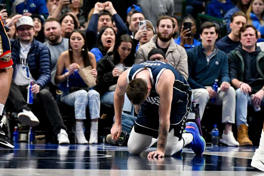 Mavs' Luka Doncic (negende van rechts) na het oplopen van zijn blessure tijdens de wedstrijd vannacht