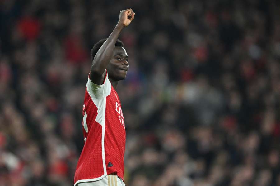 Arsenal's English midfielder #07 Bukayo Saka celebrates after scoring their third goal