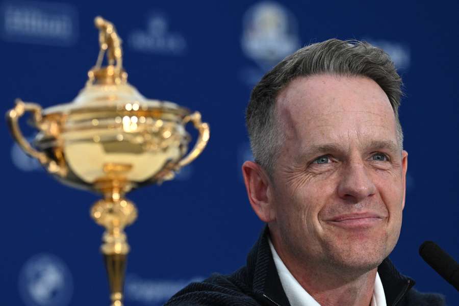 Europe's captain Donald sits alongside the Ryder Cup trophy