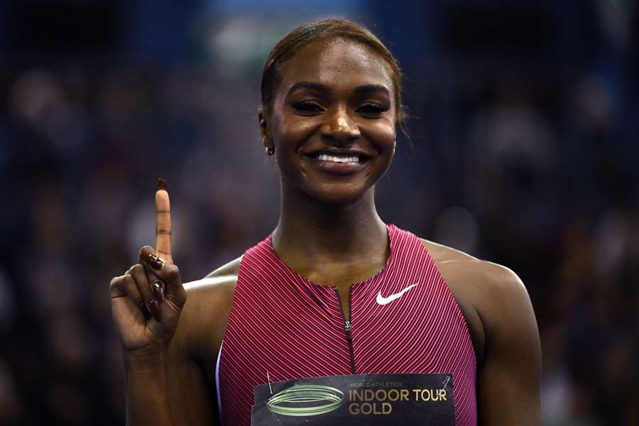 Britain's Dina Asher-Smith poses for a photograph after her victory