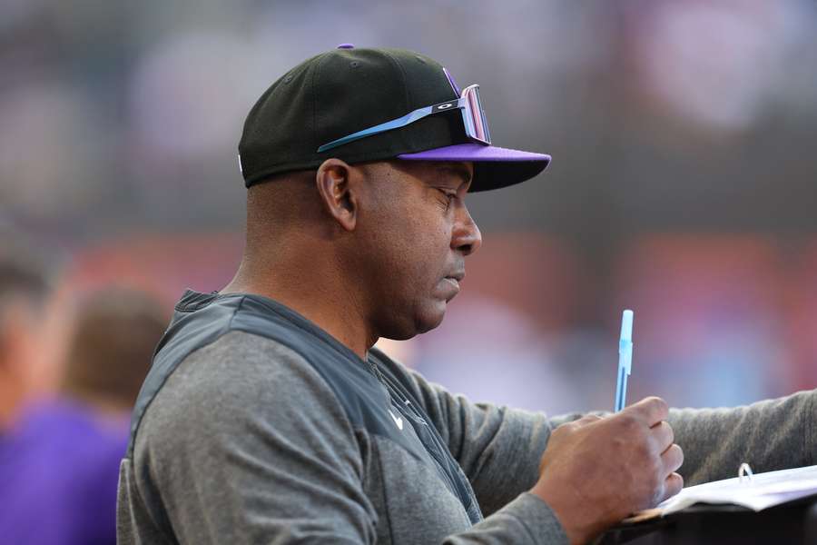 Colorado Rockies hitting coach Hensley Meulens taking notes during a game against the New York Mets