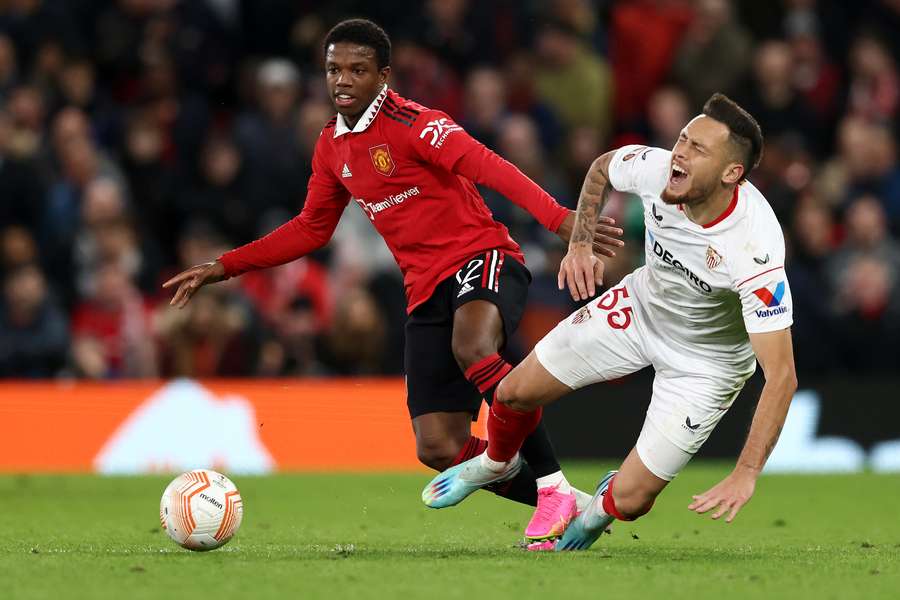 Manchester United's Dutch defender Tyrell Malacia vies with Sevilla's Argentinian midfielder Lucas Ocampos