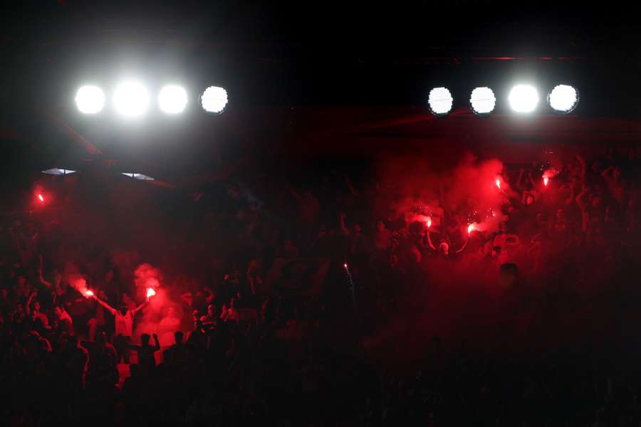 Benfica fans light flares on the stands during the UEFA Champions League quarter final first leg football match against Inter Milan
